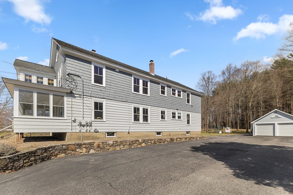 183 Pleasant Street, Unit 2 Grafton, MA 01560 - Photo 29 of 34 a front view of a house with a road