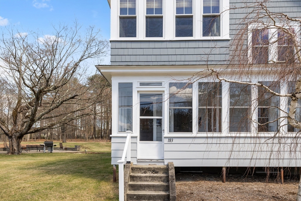 183 Pleasant Street, Unit 2 Grafton, MA 01560 - Photo 31 of 34 a front view of a building with a garden