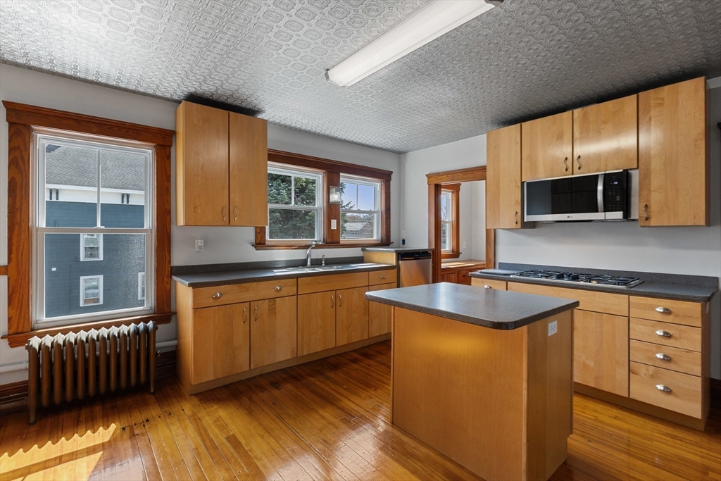 183 Pleasant Street, Unit 2 Grafton, MA 01560 - Photo 5 of 34 a kitchen with stainless steel appliances granite countertop a sink stove and cabinets