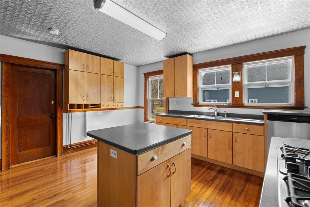 183 Pleasant Street, Unit 2 Grafton, MA 01560 - Photo 7 of 34 a kitchen with stainless steel appliances granite countertop a sink a stove and a refrigerator