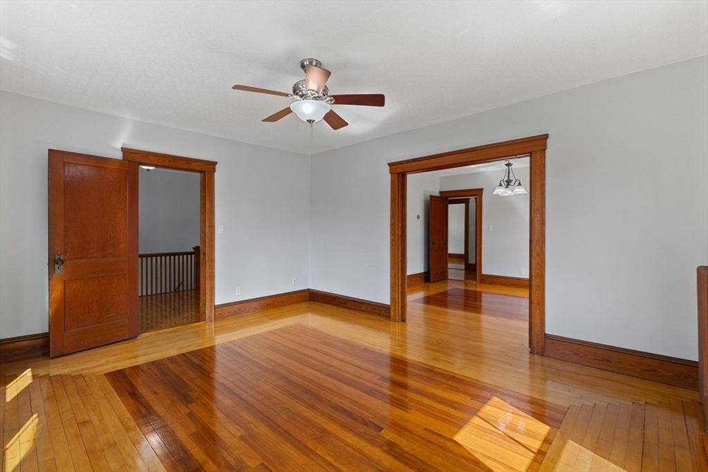 183 Pleasant Street, Unit 2 Grafton, MA 01560 - Photo 10 of 34 a view of empty room with wooden floor and fan