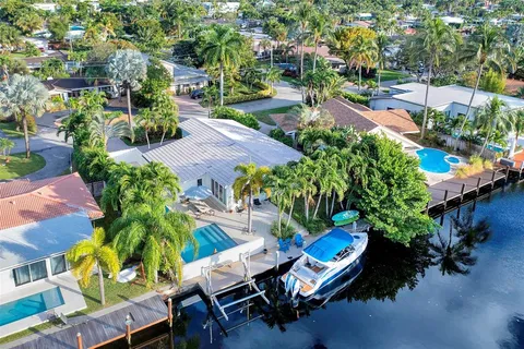 an aerial view of a swimming pool with outdoor seating