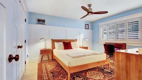 a bathroom with a painting on the wall and a shower