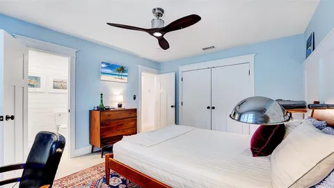 a view of a patio with couple of furniture and garden