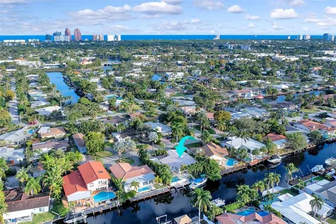 an aerial view of residential houses with outdoor space and swimming pool