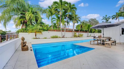 a living room with furniture and large windows