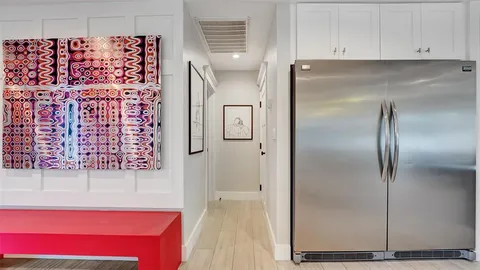 a living room with furniture gym equipment and a large window