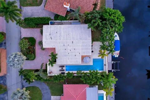 a hallway with beautiful frames and flower vase