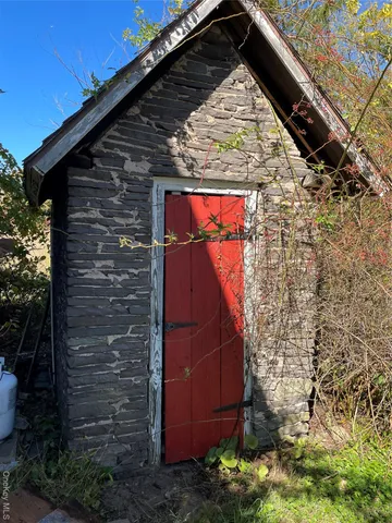 a view of water heater and wooden wall