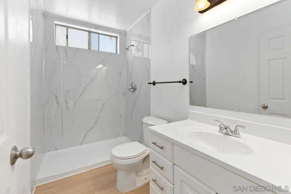13749 Avenida Del Charro El Cajon, CA 92021 - Photo 14 of 24 a bathroom with a sink a toilet and shower