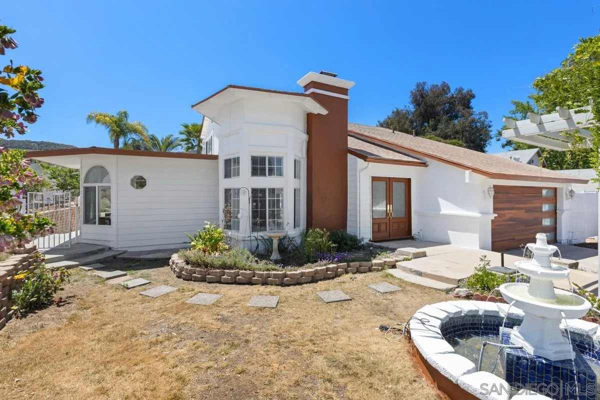 13749 Avenida Del Charro El Cajon, CA 92021 - Photo 2 of 24 a front view of a house with a yard