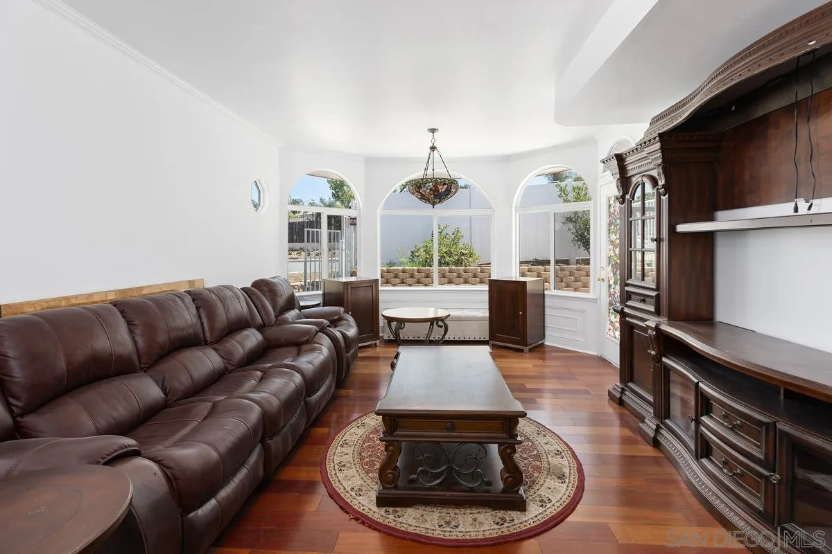 13749 Avenida Del Charro El Cajon, CA 92021 - Photo 6 of 24 a living room with furniture a flat screen tv and kitchen view