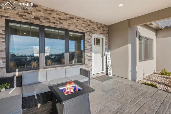 a living room with furniture and a floor to ceiling window