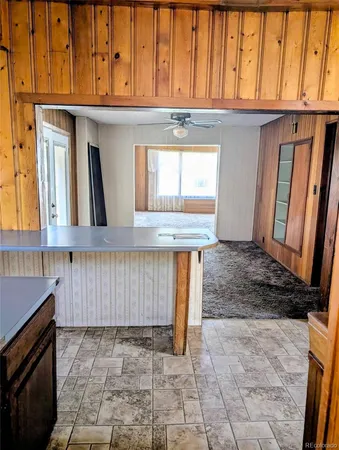 a view of kitchen with granite countertop wooden cabinets