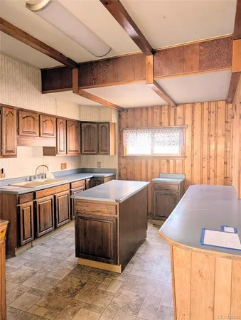 a kitchen with stainless steel appliances kitchen island granite countertop a sink and counter space