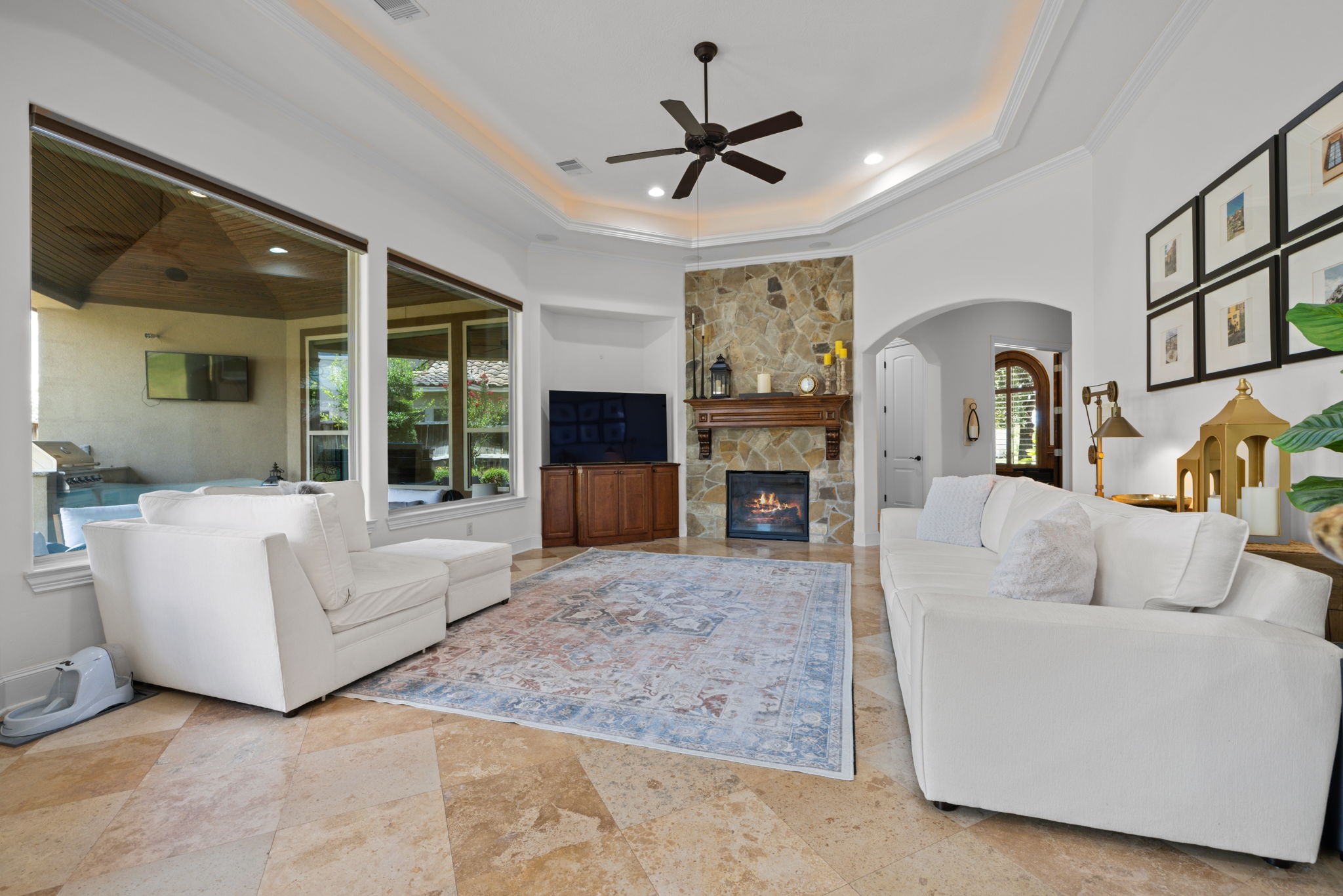 58 Shadow Creek Ridge Drive Spring, TX 77389 - Photo 13 of 49 Family room with tall ceilings, stone gas fireplace and wall of windows with views of the patio