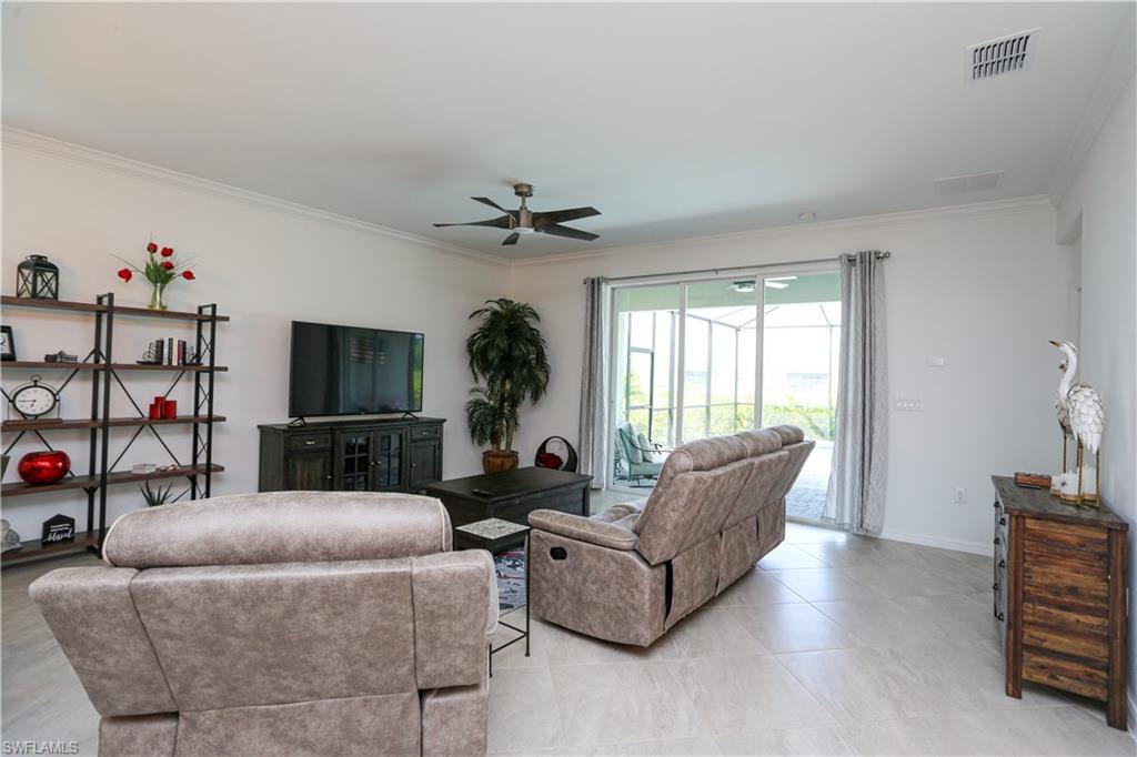 2155 Hamlin Street Naples, FL 34120 - Photo 45 of 50 Living room with ornamental molding, ceiling fan, and light tile patterned floors