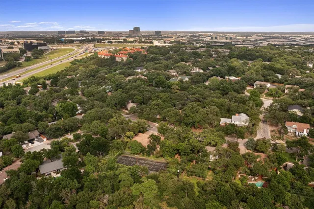 an aerial view of residential houses with city view