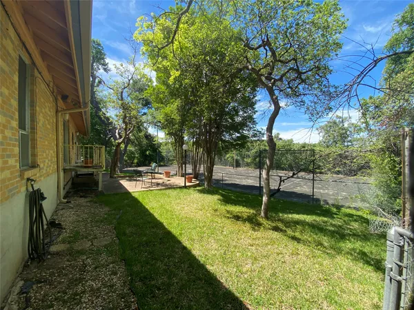 a view of a backyard with swimming pool