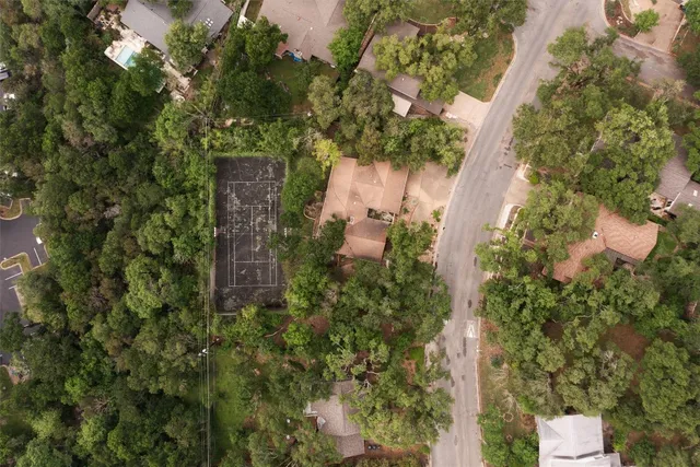 an aerial view of a house with yard