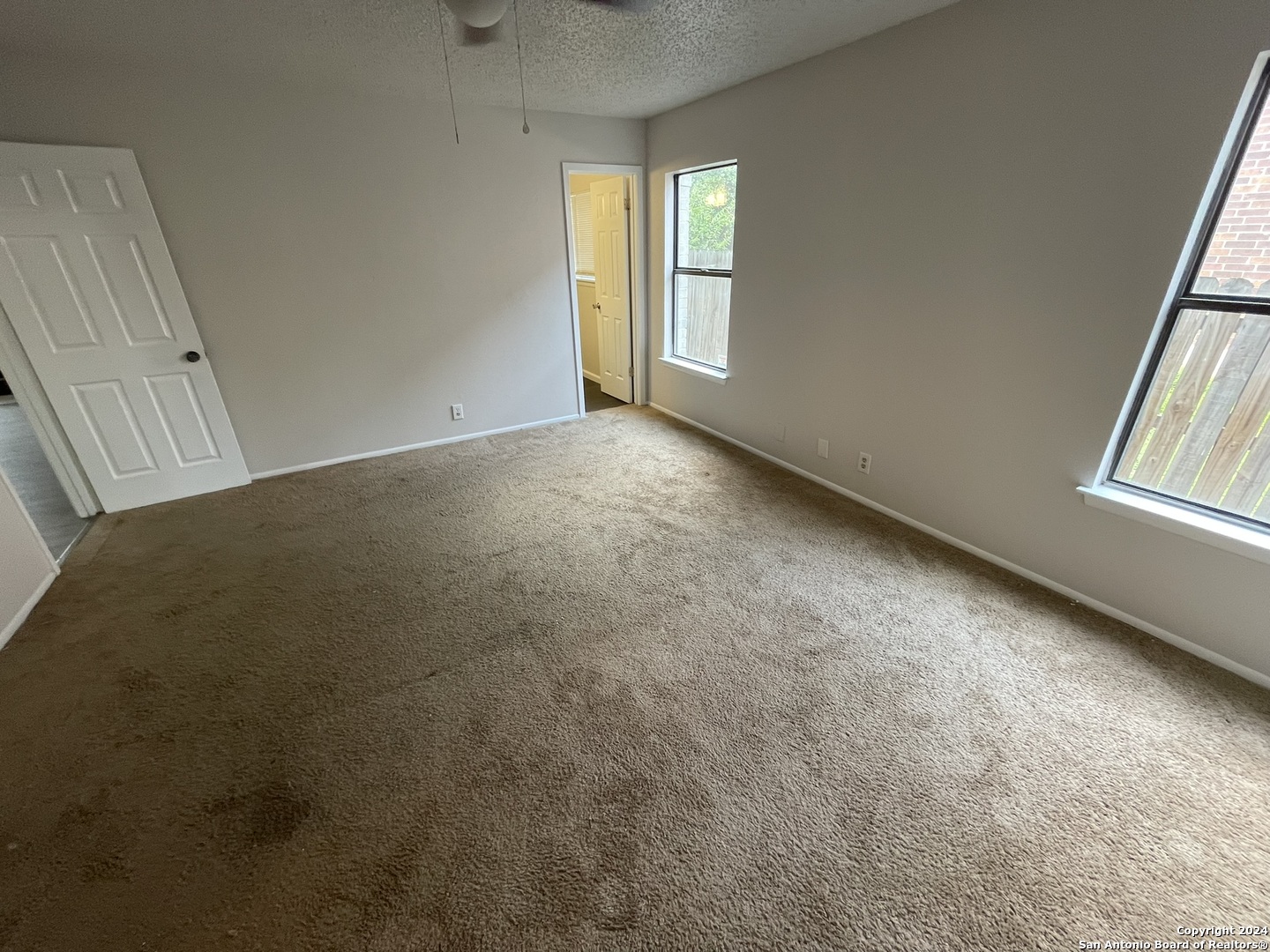 9235 Ridge Post San Antonio, TX 78250 - Photo 13 of 30 an empty room with windows