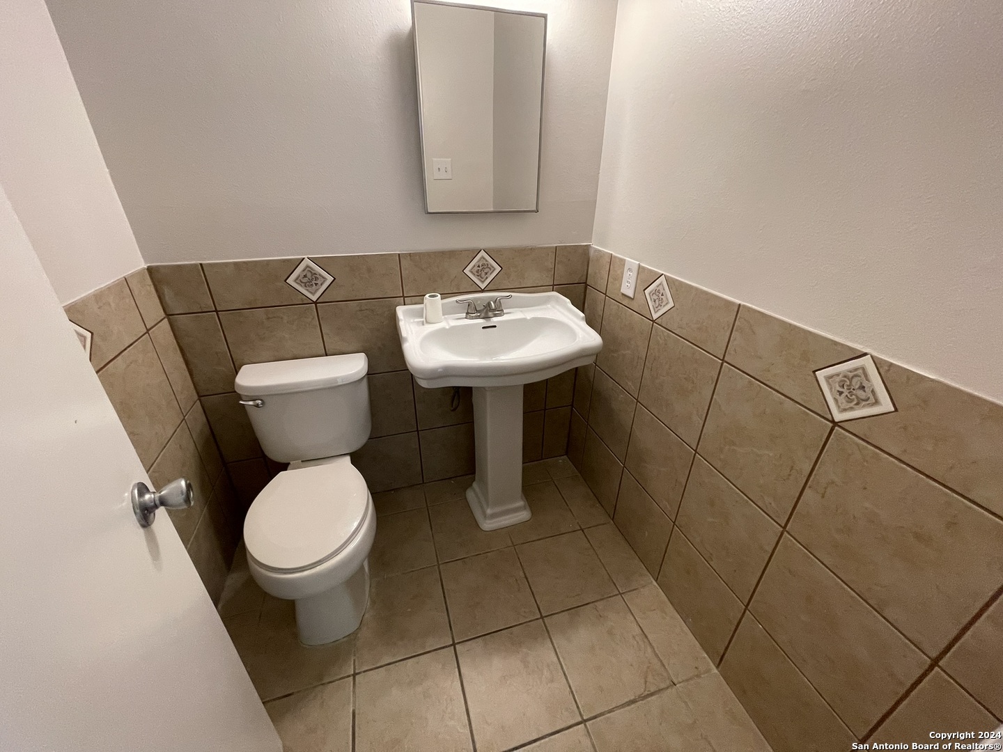 9235 Ridge Post San Antonio, TX 78250 - Photo 18 of 30 a bathroom with a sink toilet and a mirror