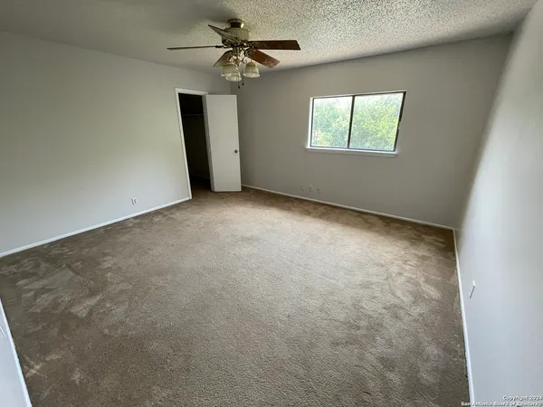 an empty room with windows and closet