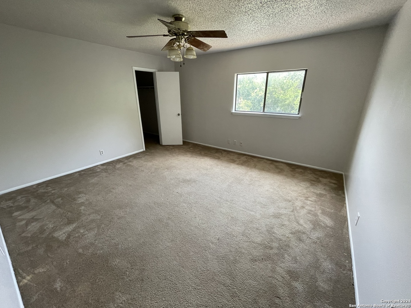 9235 Ridge Post San Antonio, TX 78250 - Photo 20 of 30 an empty room with windows and fan