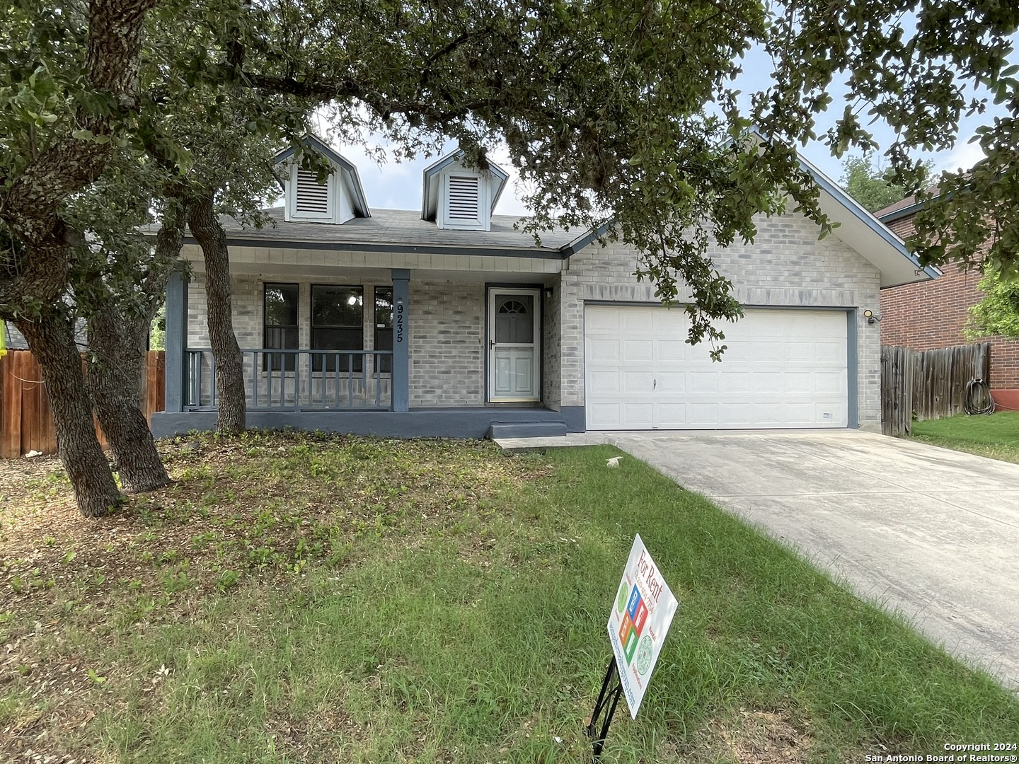 9235 Ridge Post San Antonio, TX 78250 - Photo 2 of 30 a view of an house with backyard space and tree