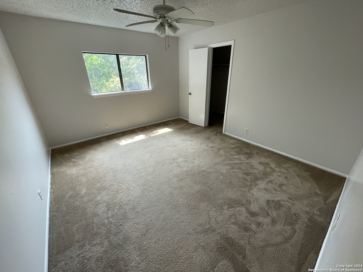 9235 Ridge Post San Antonio, TX 78250 - Photo 21 of 30 an empty room with windows and closet