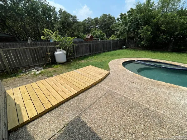 a swimming pool with outdoor seating and yard