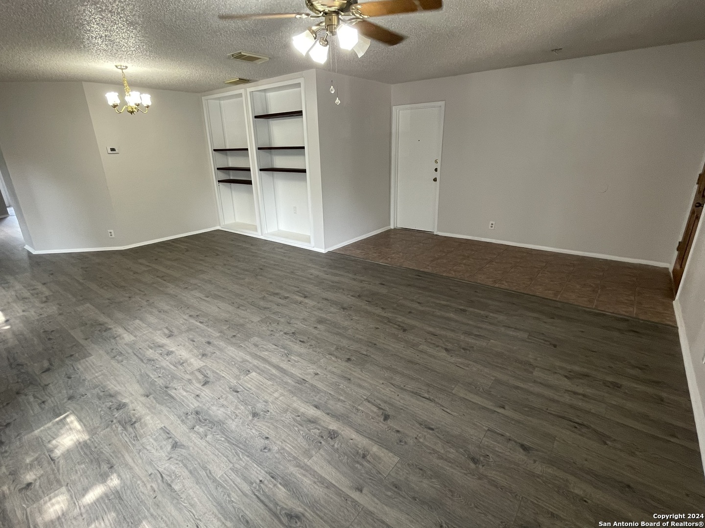 9235 Ridge Post San Antonio, TX 78250 - Photo 6 of 30 a view of a room with wooden floor and a ceiling fan