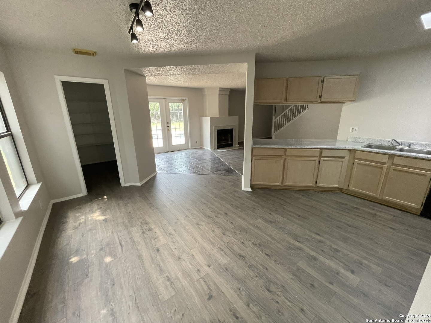 9235 Ridge Post San Antonio, TX 78250 - Photo 7 of 30 a view of a kitchen with a sink and dishwasher wooden floor