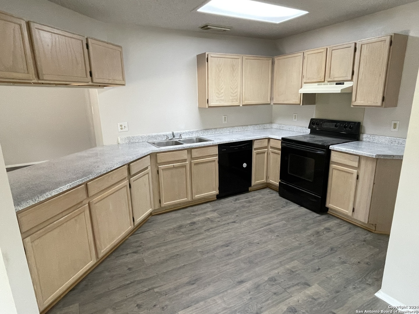 9235 Ridge Post San Antonio, TX 78250 - Photo 8 of 30 a kitchen with stainless steel appliances granite countertop a stove sink and cabinets