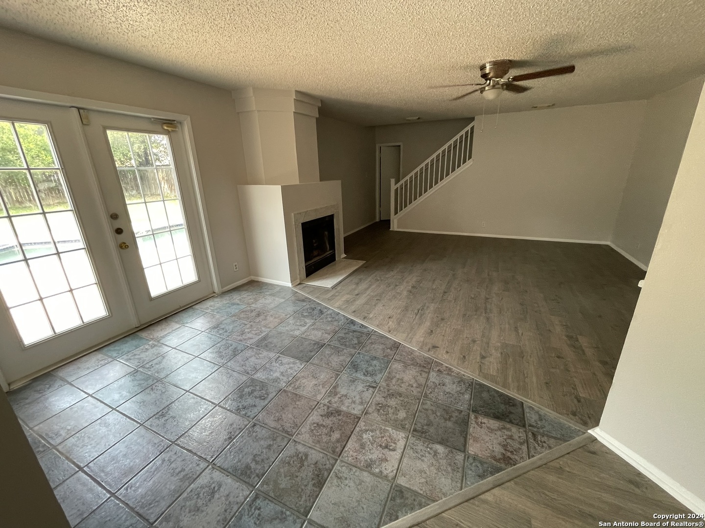 9235 Ridge Post San Antonio, TX 78250 - Photo 9 of 30 a view of an empty room with a fireplace and a window