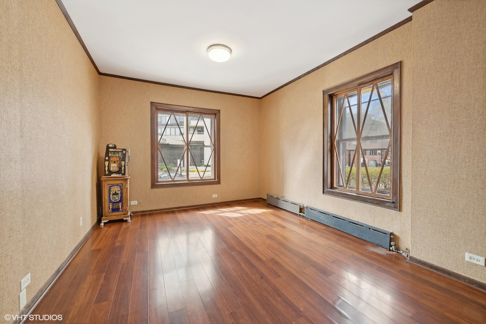 700 West Irving Park Road, Unit A1 Chicago, IL 60613 - Photo 17 of 20 an empty room with wooden floor and windows