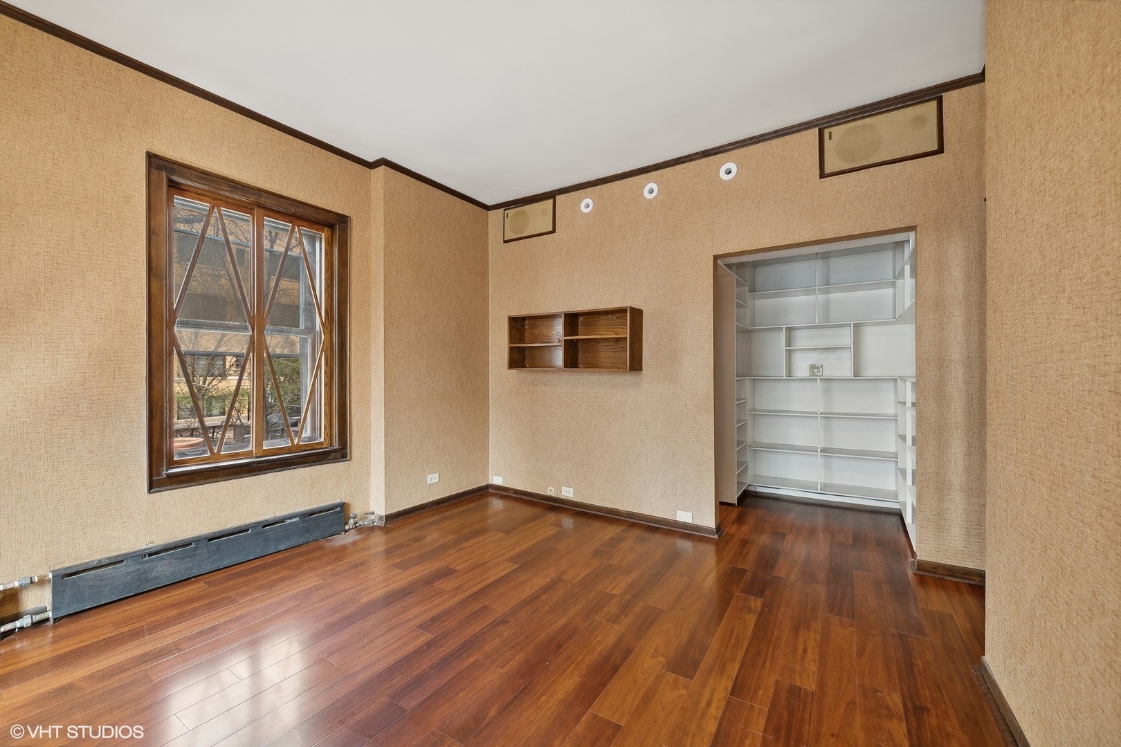 700 West Irving Park Road, Unit A1 Chicago, IL 60613 - Photo 18 of 20 a view of an empty room with wooden floor and a window
