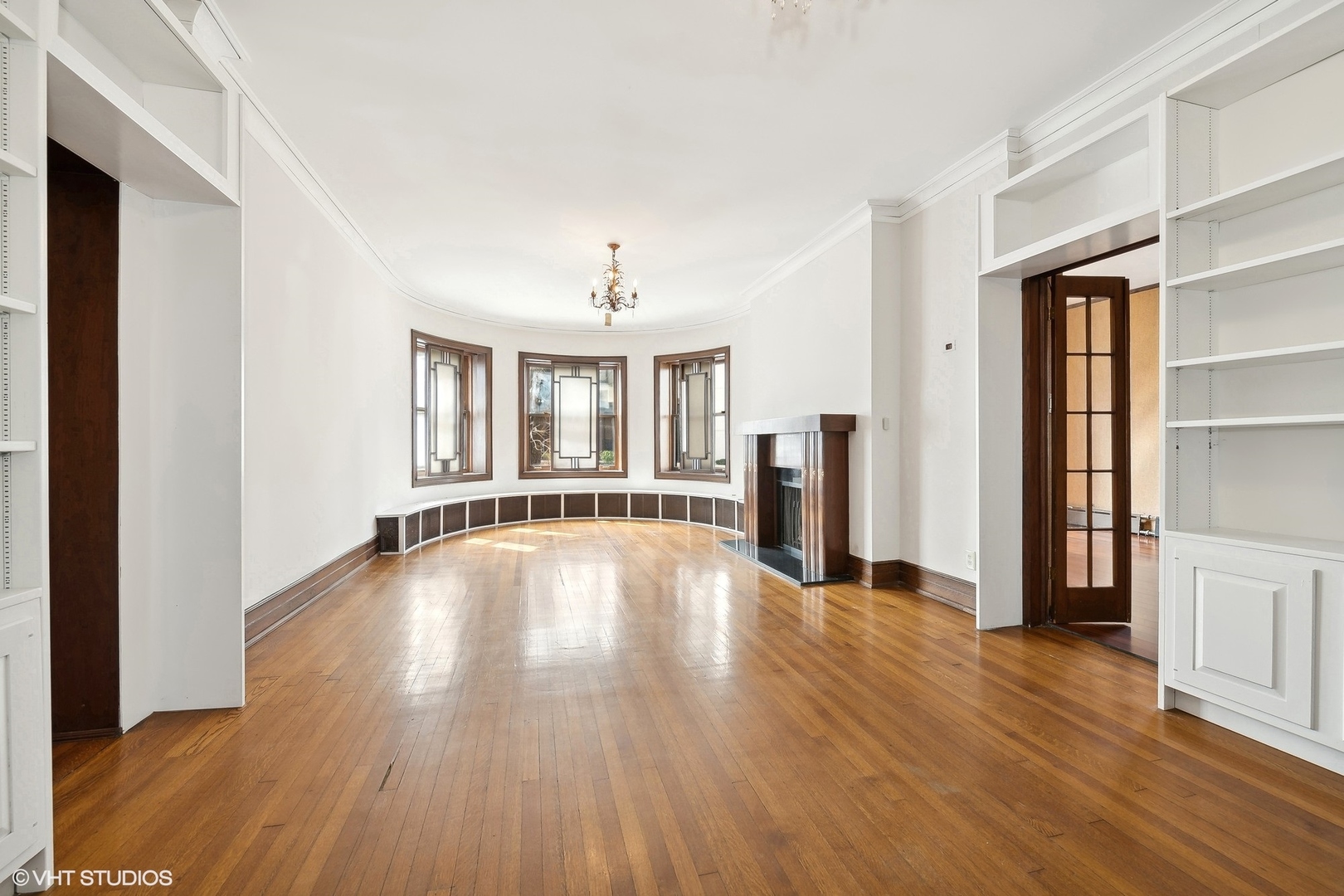 700 West Irving Park Road, Unit A1 Chicago, IL 60613 - Photo 2 of 20 a view of an empty room with window and wooden floor