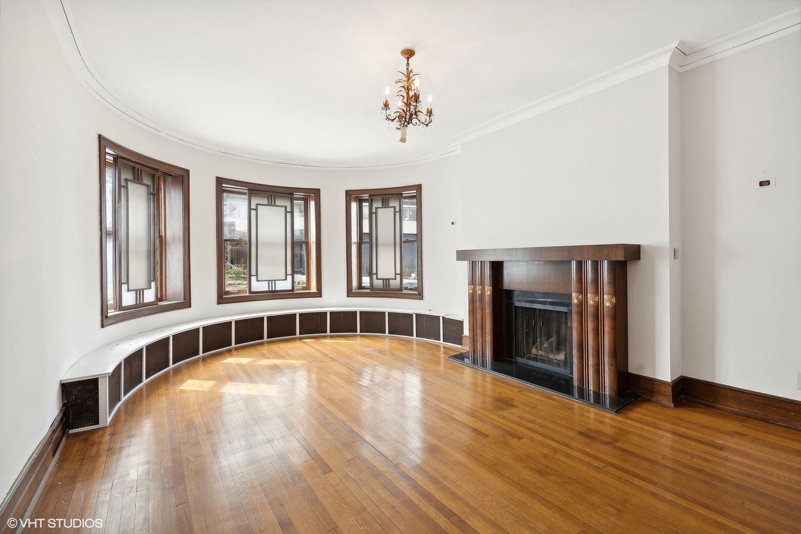 700 West Irving Park Road, Unit A1 Chicago, IL 60613 - Photo 3 of 20 a view of an empty room with wooden floor and a window