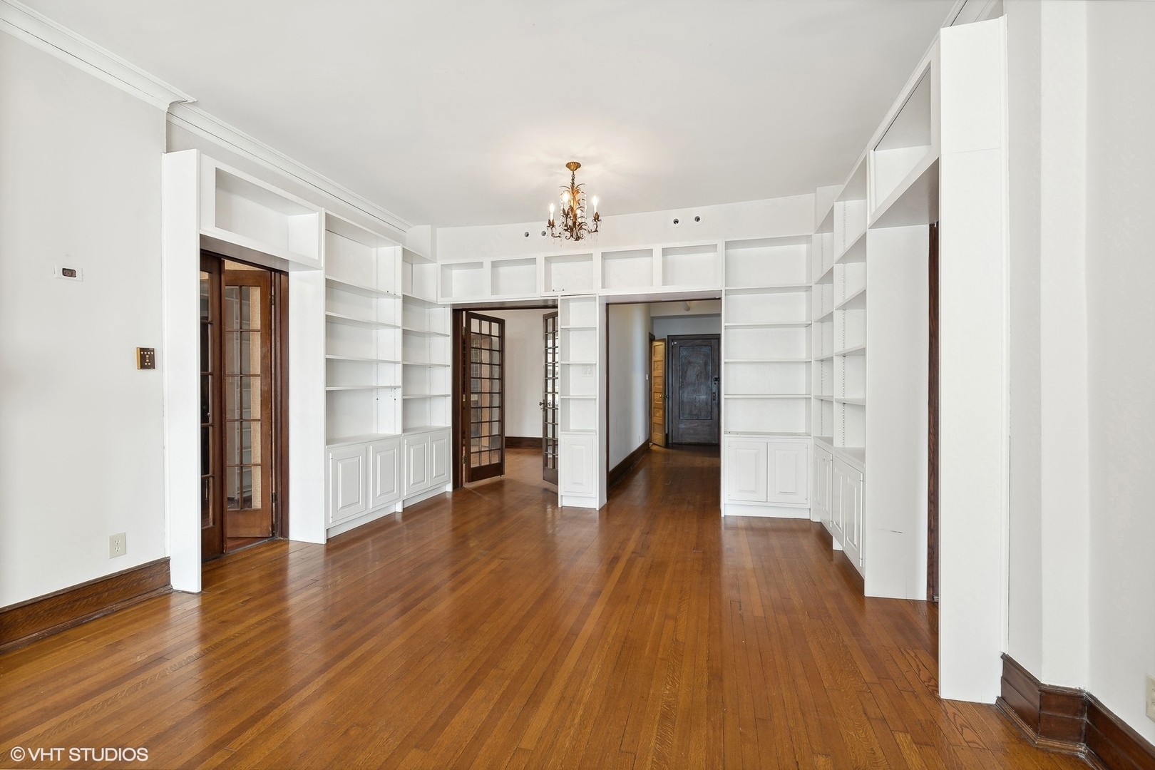 700 West Irving Park Road, Unit A1 Chicago, IL 60613 - Photo 4 of 20 an empty room with wooden floor chandelier and windows