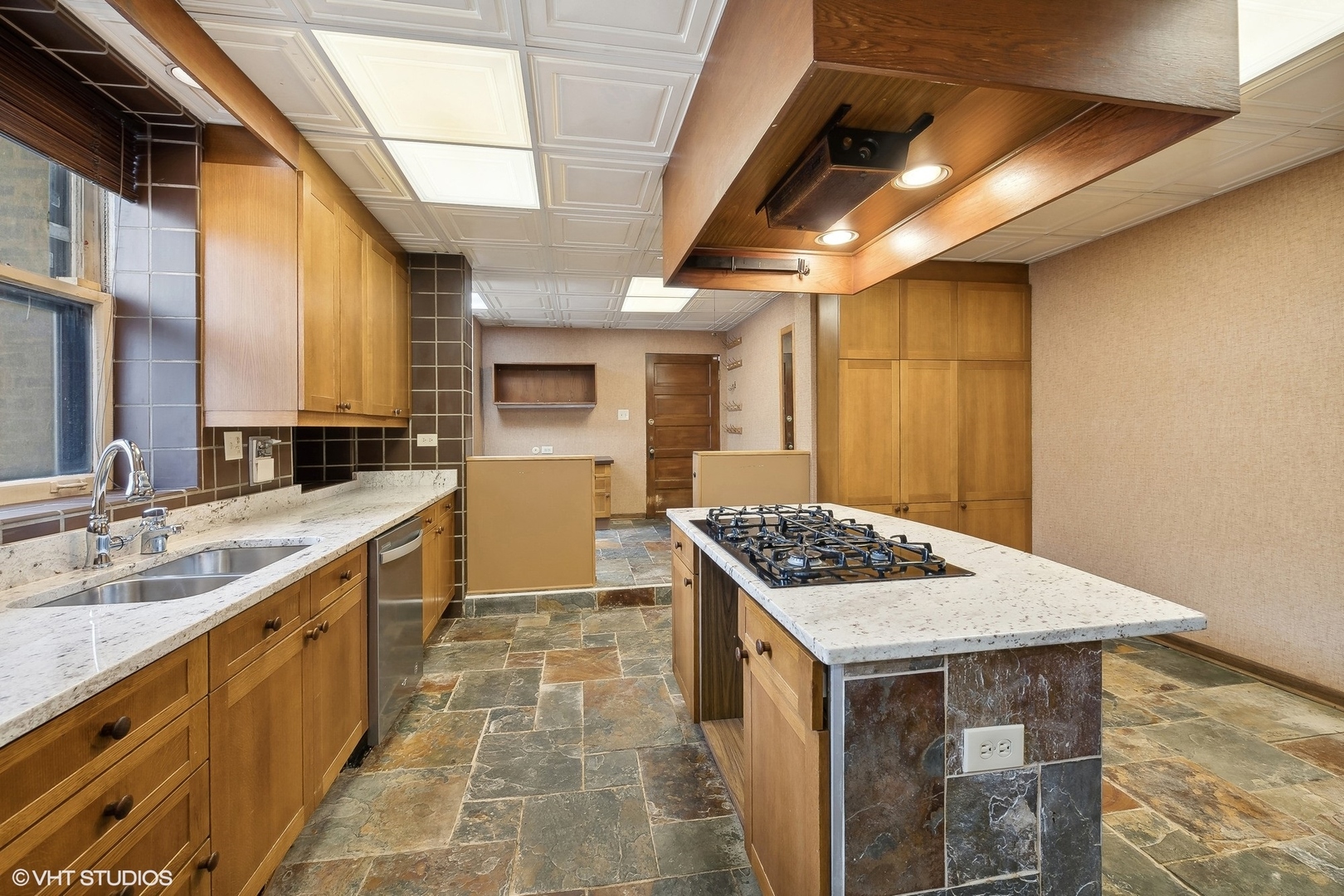 700 West Irving Park Road, Unit A1 Chicago, IL 60613 - Photo 7 of 20 a kitchen with stainless steel appliances granite countertop a stove a sink and a microwave