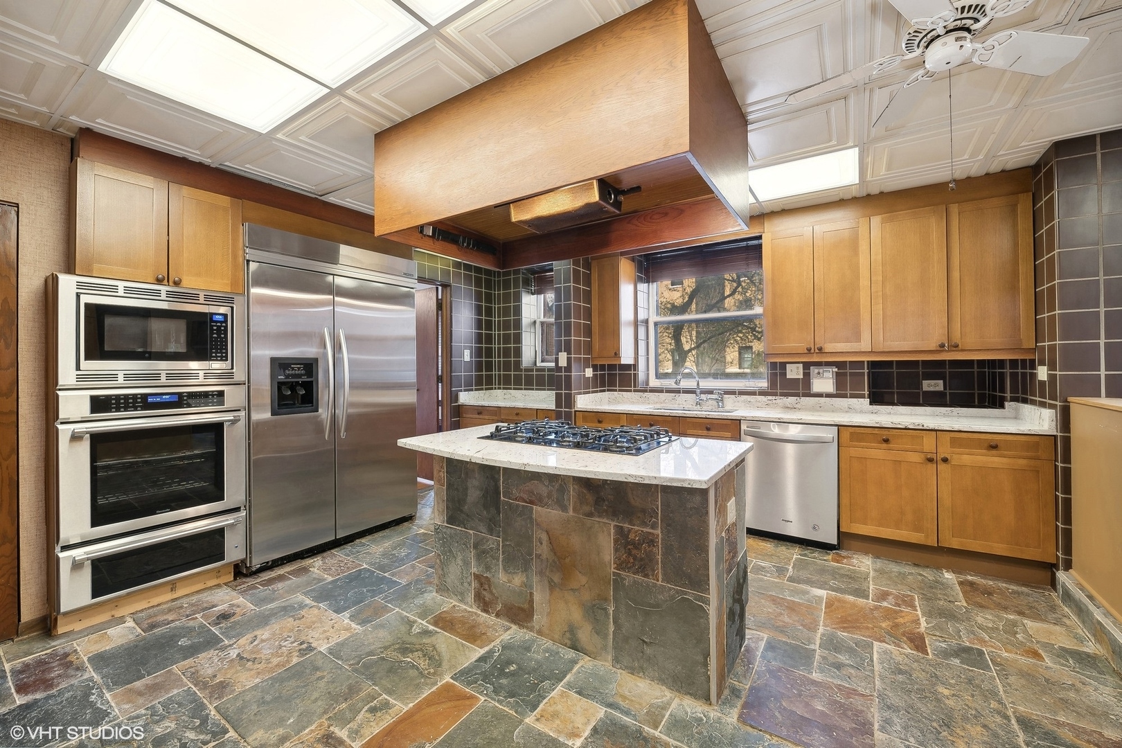 700 West Irving Park Road, Unit A1 Chicago, IL 60613 - Photo 8 of 20 a kitchen with a stove a sink and a refrigerator