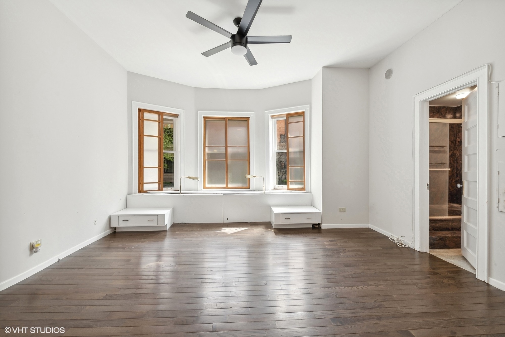 700 West Irving Park Road, Unit A1 Chicago, IL 60613 - Photo 10 of 20 an empty room with wooden floor and windows