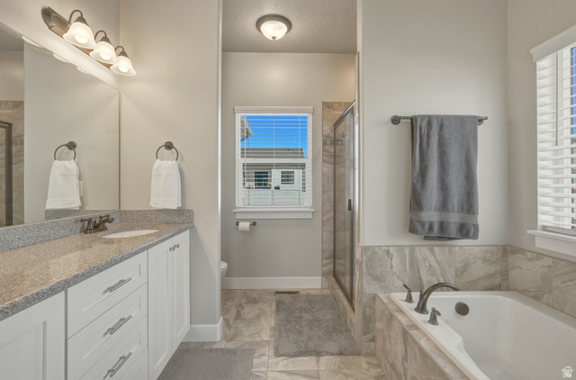 836 South 250 West Vernal, UT 84078 - Photo 17 of 56 Full bath featuring vanity, a shower stall, and a garden tub