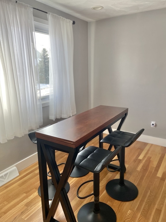 31 Blithewood Avenue, Unit 705 Worcester, MA 01604 - Photo 13 of 31 a view of a dining room with furniture and wooden floor
