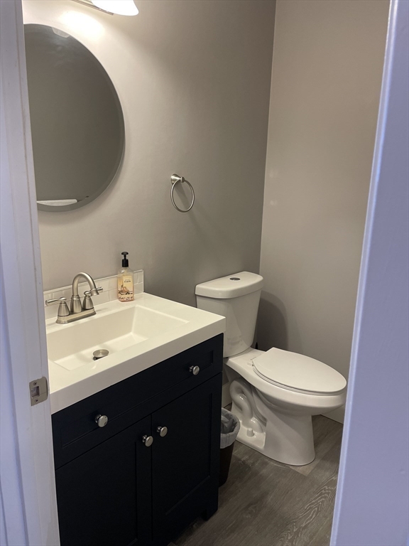 31 Blithewood Avenue, Unit 705 Worcester, MA 01604 - Photo 5 of 31 a bathroom with a toilet sink and mirror