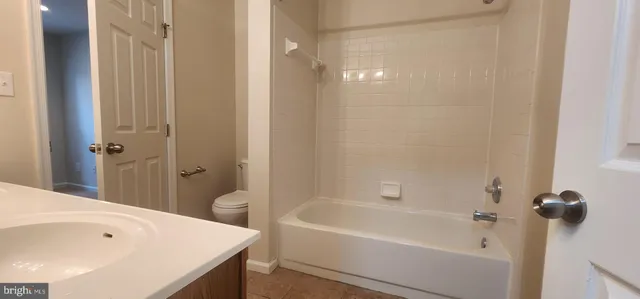 a bathroom with a tub and shower
