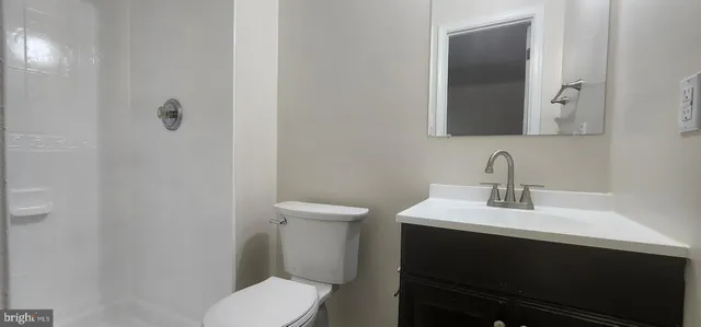a bathroom with a sink toilet and mirror