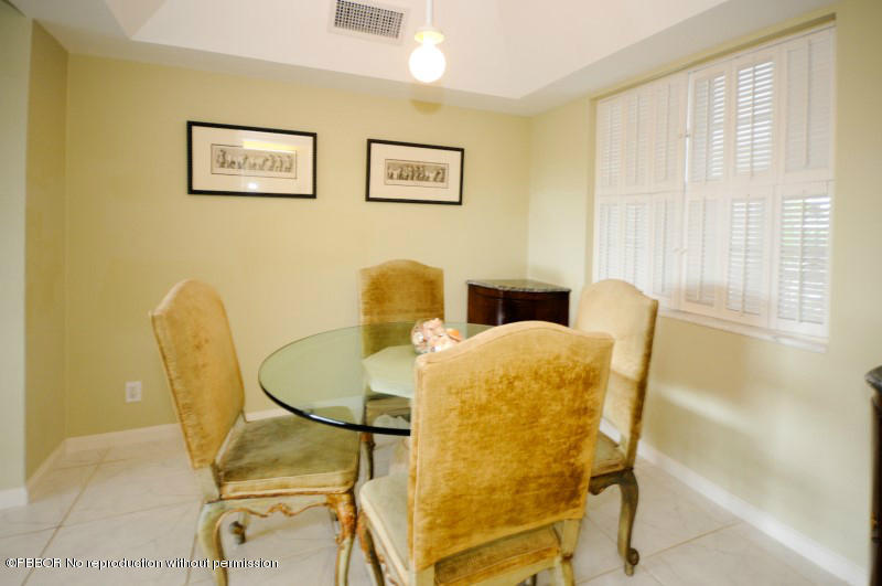 2195 Ibis Isle Road, Unit 6 Palm Beach, FL 33480 - Photo 6 of 15 a bed and a chair