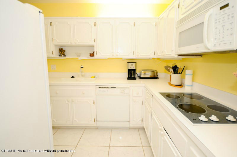 2195 Ibis Isle Road, Unit 6 Palm Beach, FL 33480 - Photo 8 of 15 a kitchen with a sink and cabinets